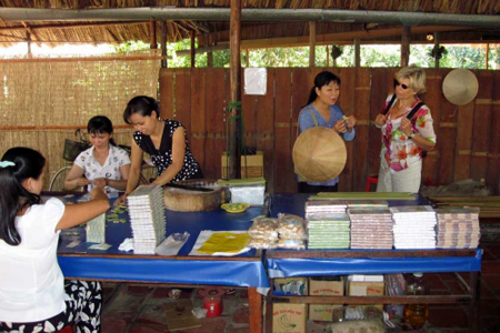Travelers visiting coconut candy workshop in Ben Tre