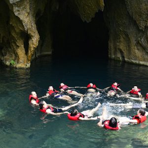 Swimming in the crystal clear water of E cave (Trung Tre cave)