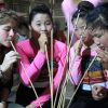 Tourist with ethnic girls drinking Can Wine