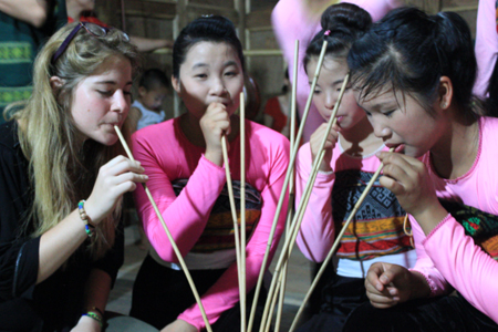 Tourist with ethnic girls drinking Can Wine