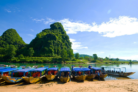 Walk to boat whraf and take a pleasant boat trip to Phong Nha Cave