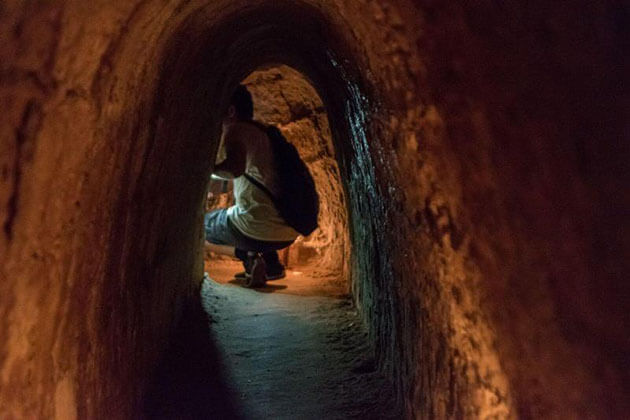 Tourist crawling at Cu Chi Tunnels