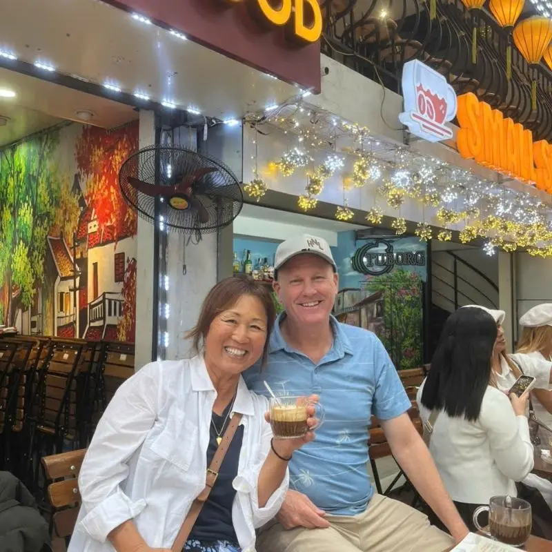 Friendly local guide and guests on a street food tour – Viet Vision Travel reviews in action