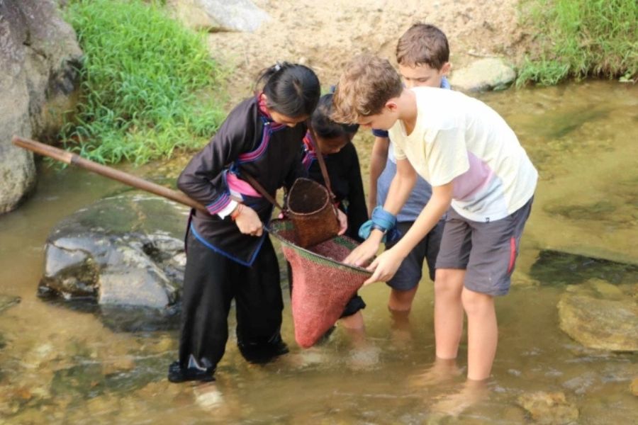 sustainable travel in vietnam catching fish with tay host