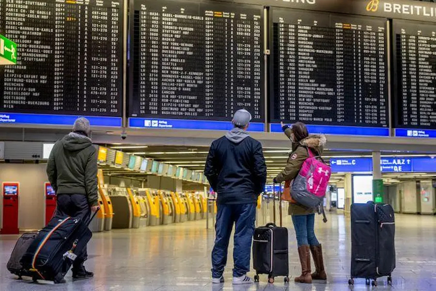 travelers checking flight information after an emergency landing